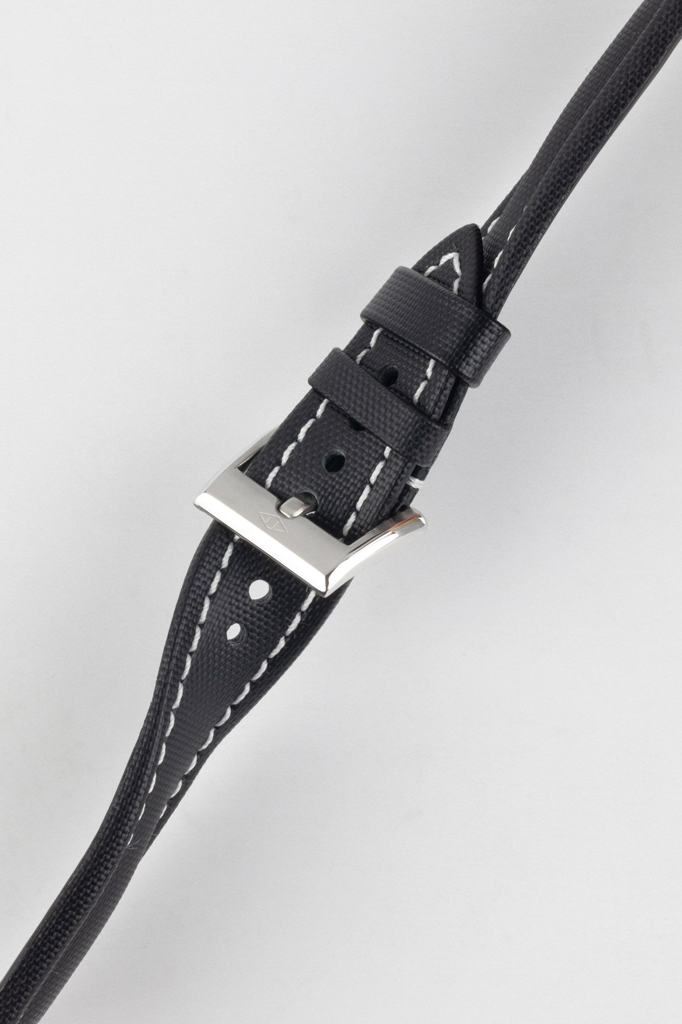 Black Artem Classic Sailcloth with white stitching watch strap buckled and twisted to show flexibility and durability.