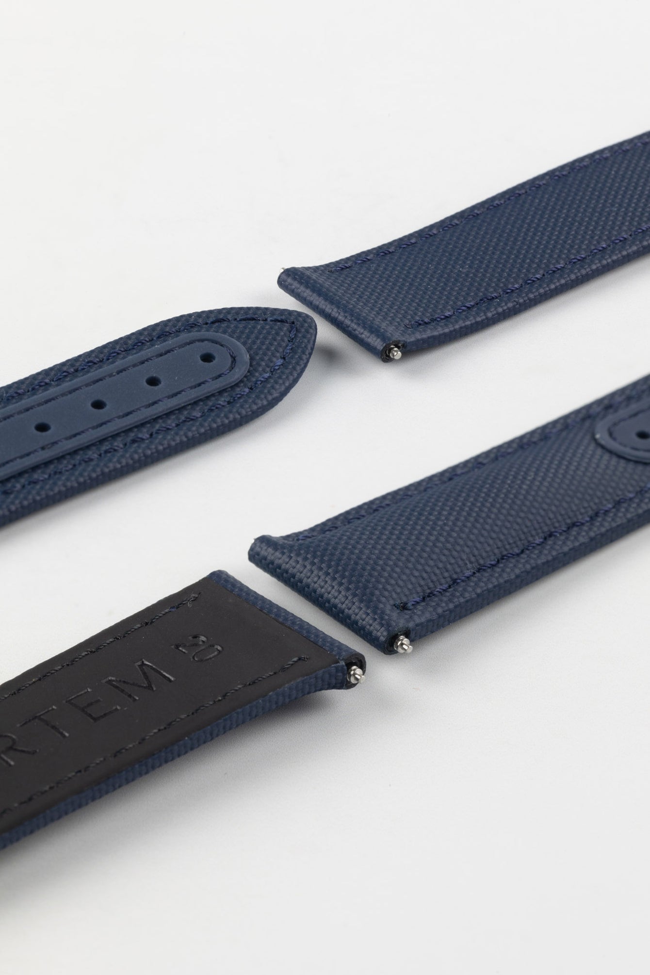 Navy Blue Artem Loop-Less Sailcloth Watch Strap without deployment clasp showing silicone adjustment holes and rubber coated leather on underside.