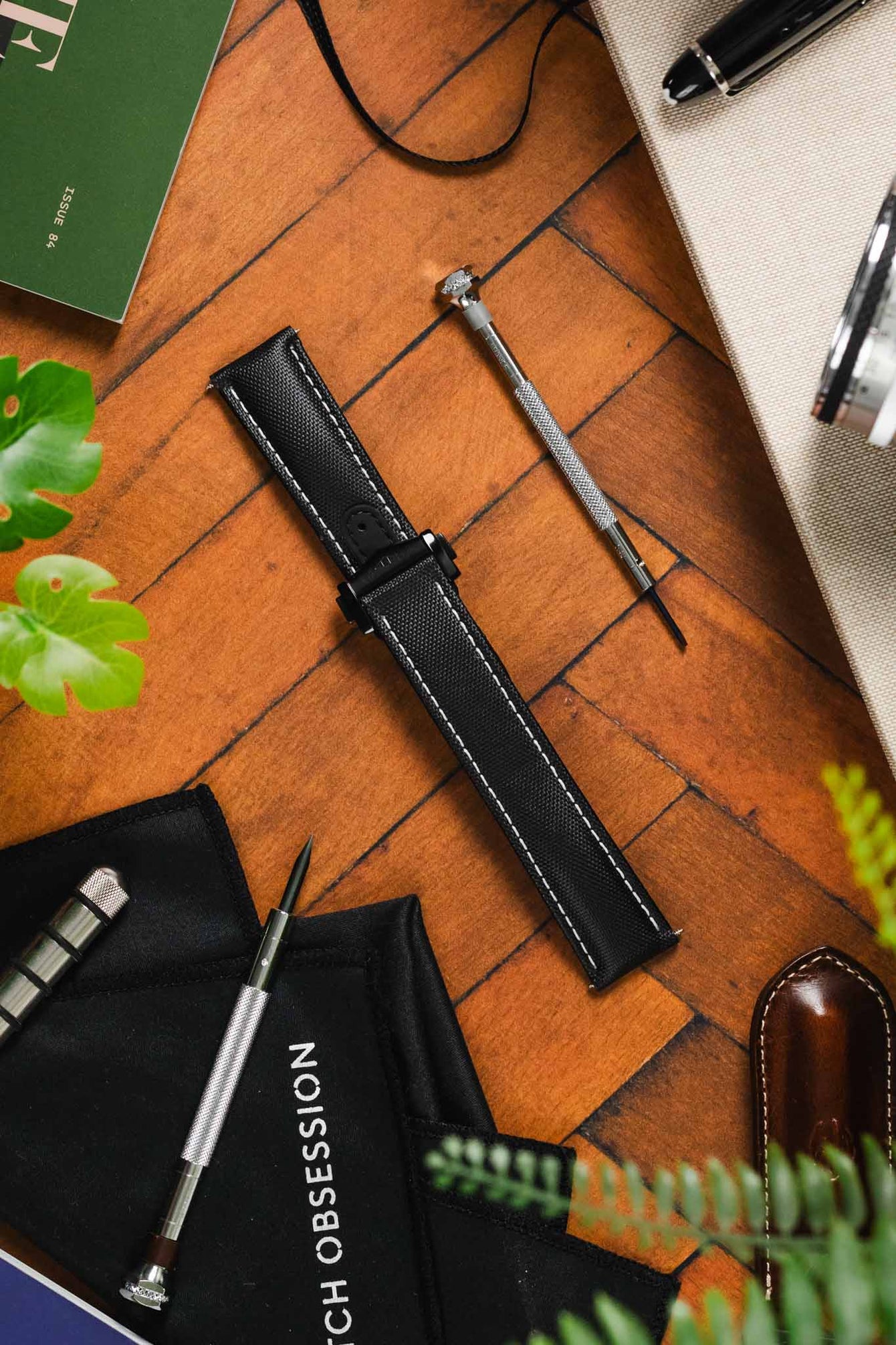 Diamond like Carbon DLC black Artem Loop-less Deployment Clasp on Black Artem Loop-less watch strap without timepiece on wooden table 