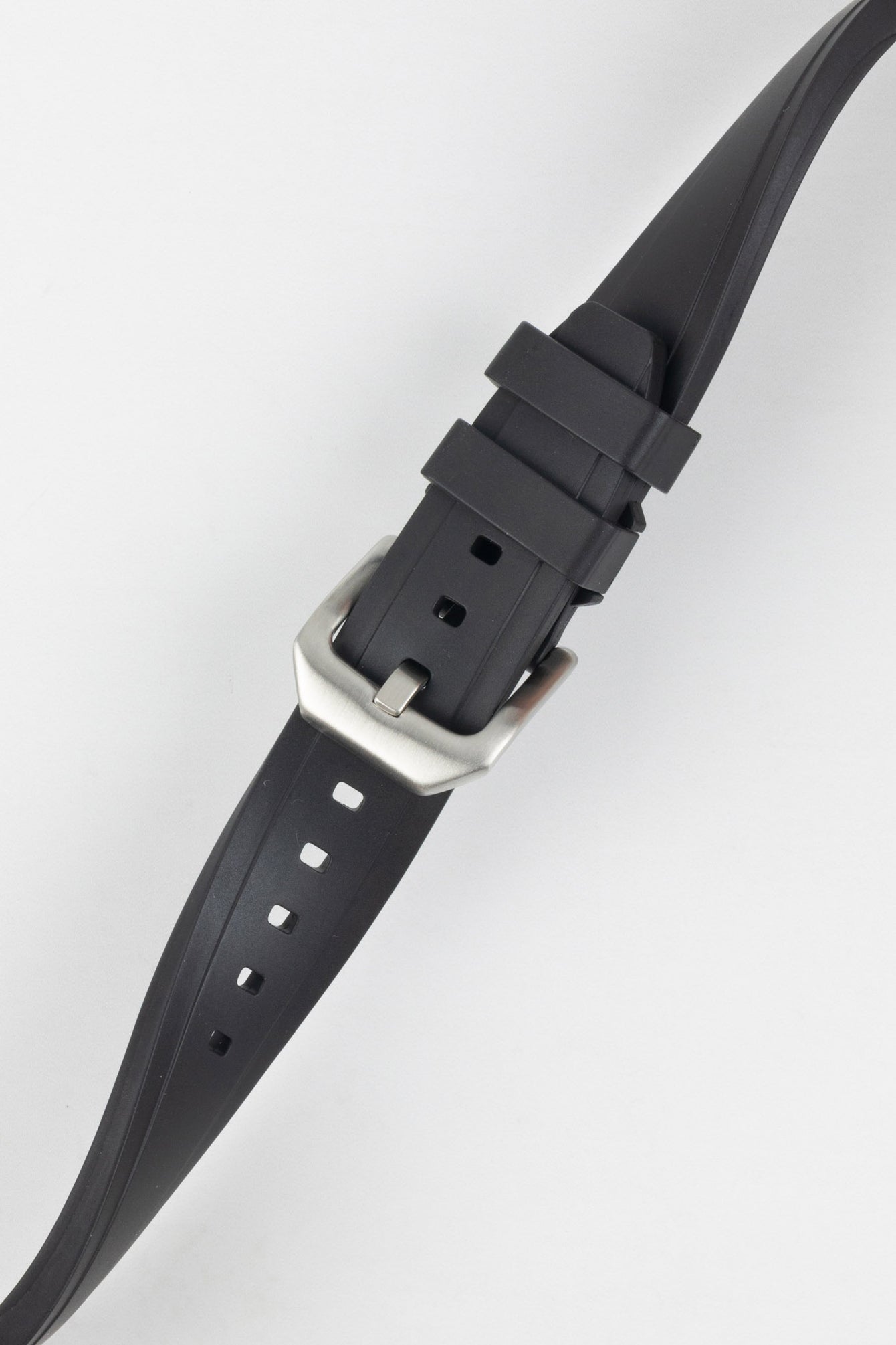 Crafter Blue watch strap done up with brushed silver stainless steel buckle twisted to show flexibility and comfort