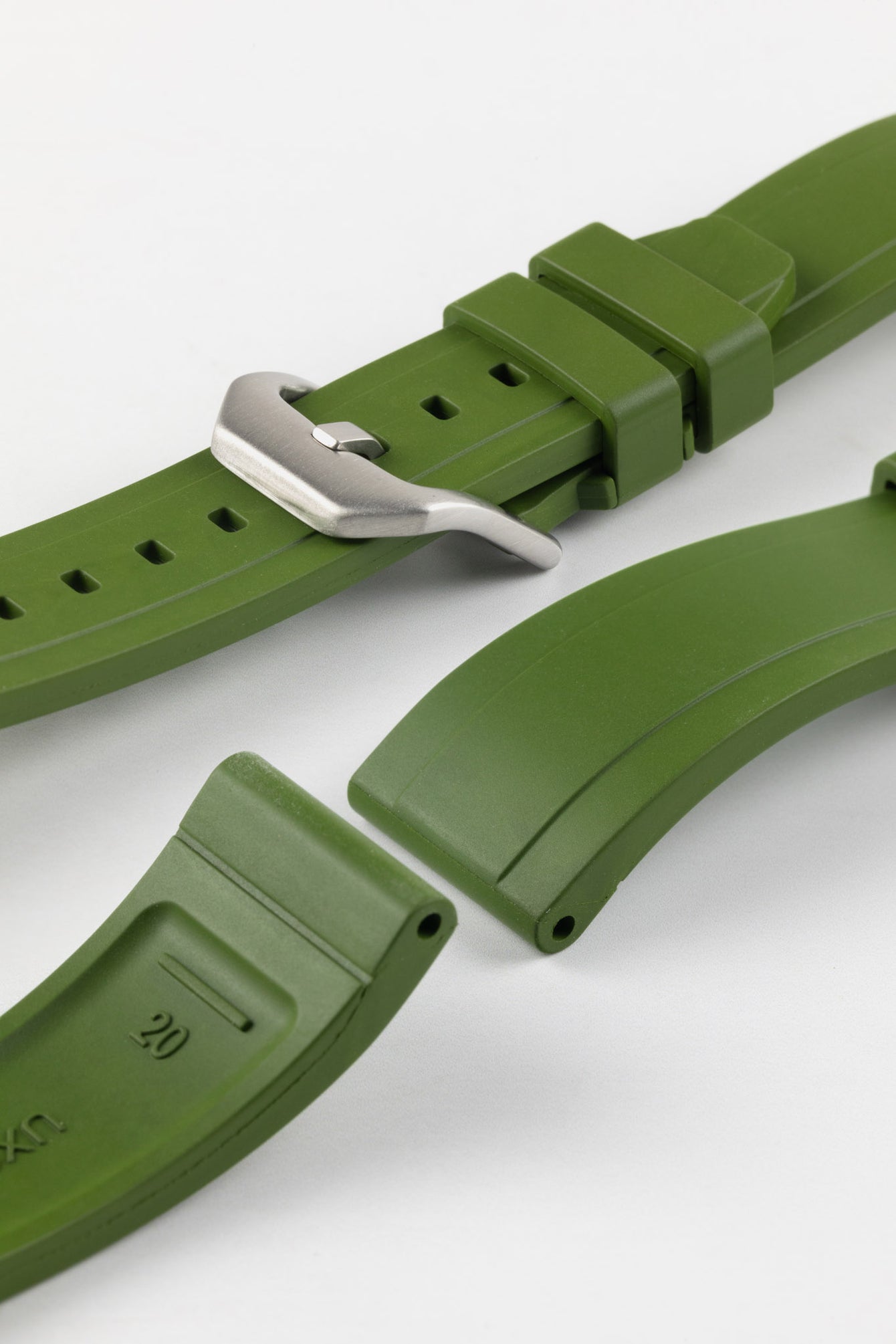 Product photo on the UX03 Rubber FKM watch strap showing the buckle done up in brushed steel, next to the underside of the strap showing the lug holes and curved fitting for comfort