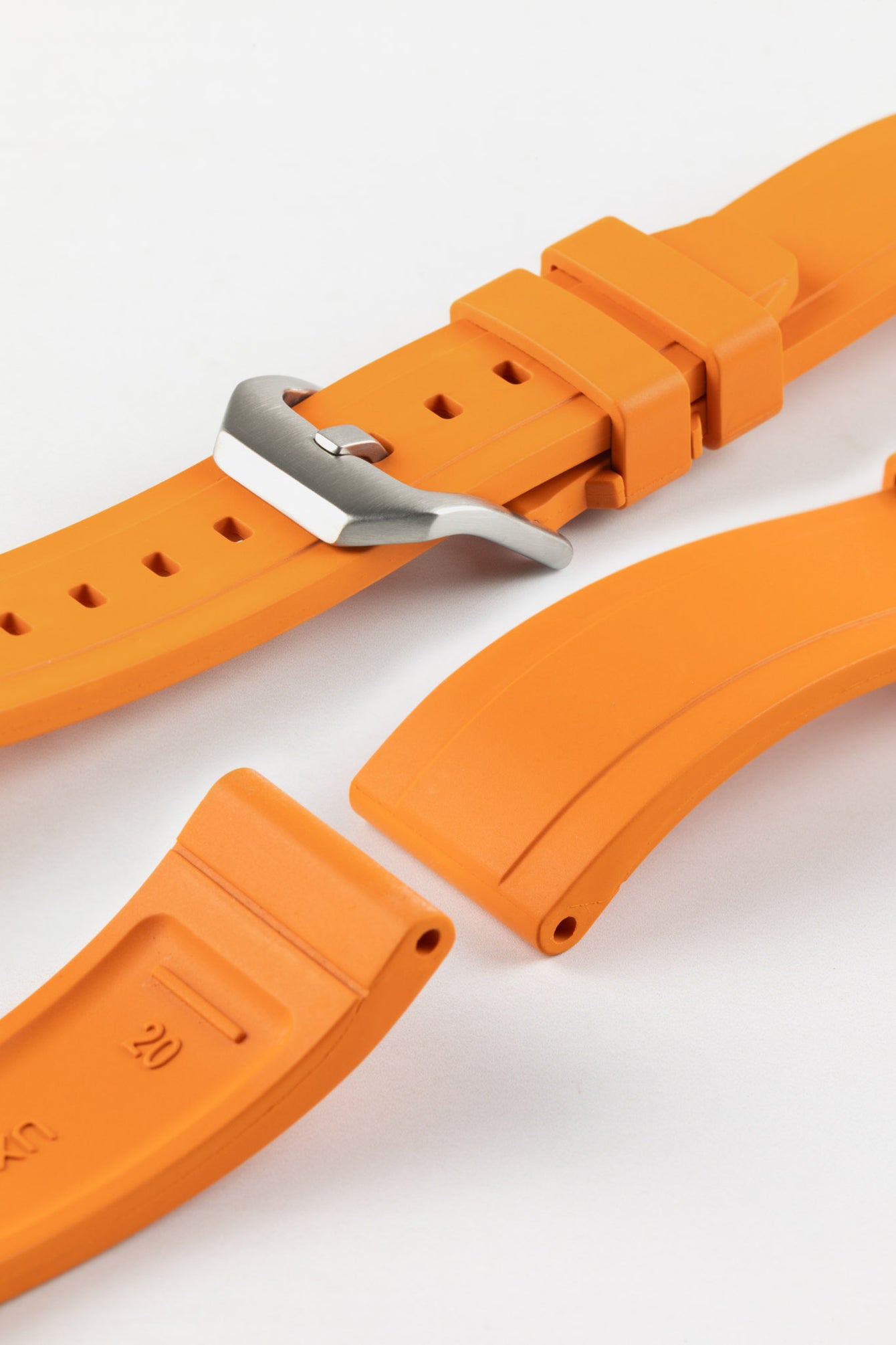 Product photo on the UX03 Rubber FKM watch strap showing the buckle done up in brushed steel, next to the underside of the strap showing the lug holes and curved fitting for comfort