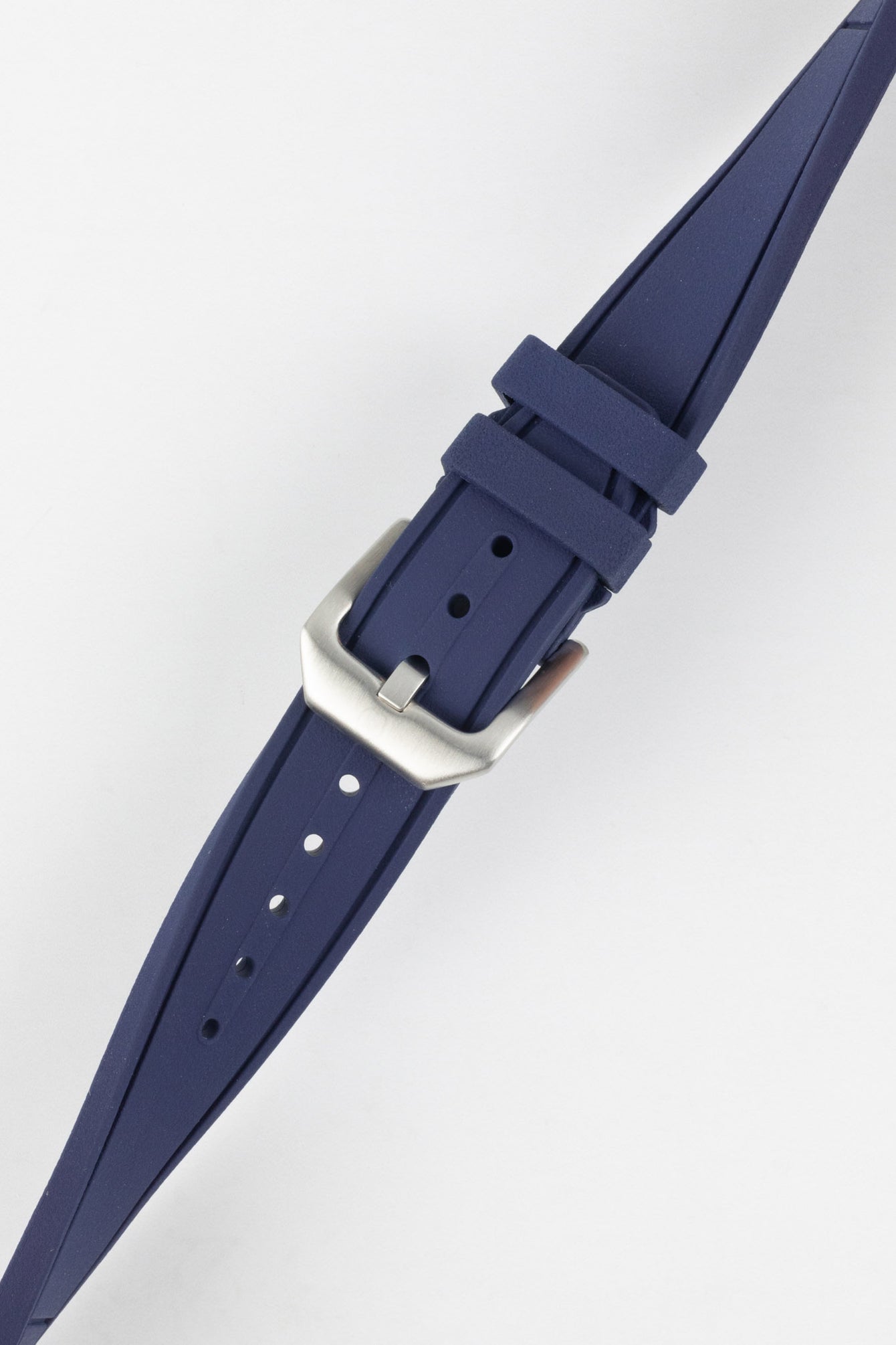 Crafter Blue watch strap done up with brushed silver stainless steel buckle twisted to show flexibility and comfort