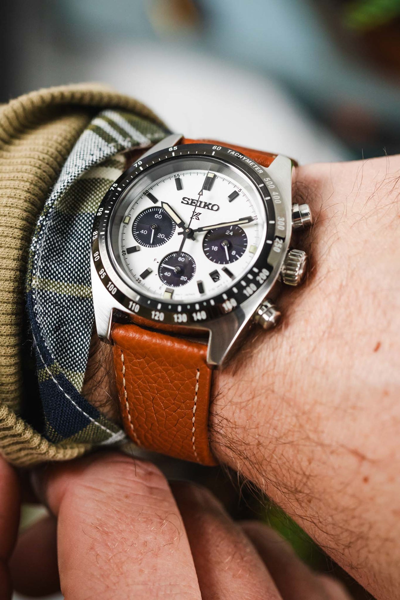 Gold Brown hirsch bologna leather watch strap fitted to seiko prospex speedtimer black and white panda chronograph on wrist