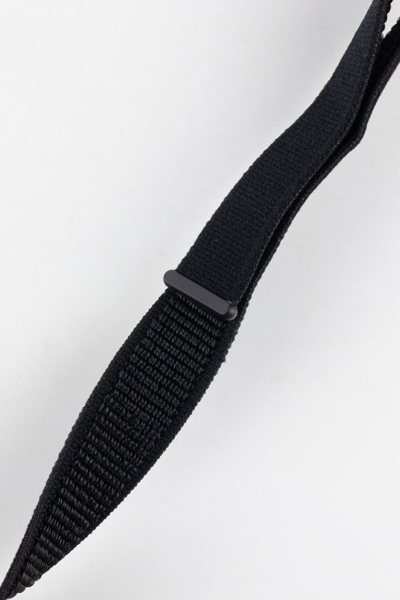 Close-up of the black Hirsch VELCRO strap, focusing on the fabric texture and the black plastic loop keeper, demonstrating the strap's construction and features.