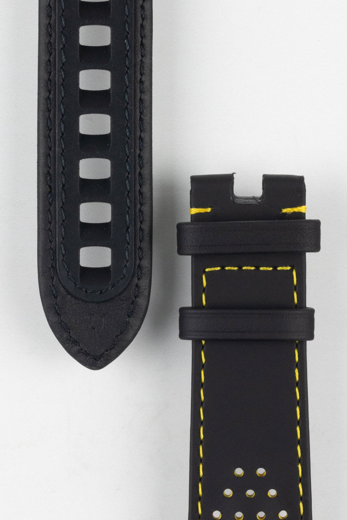 Close up of topside and lining of Omega leather Watch Strap, showing the rubber strengthening tang hole patch, perforation holes soft lining and buckle end.