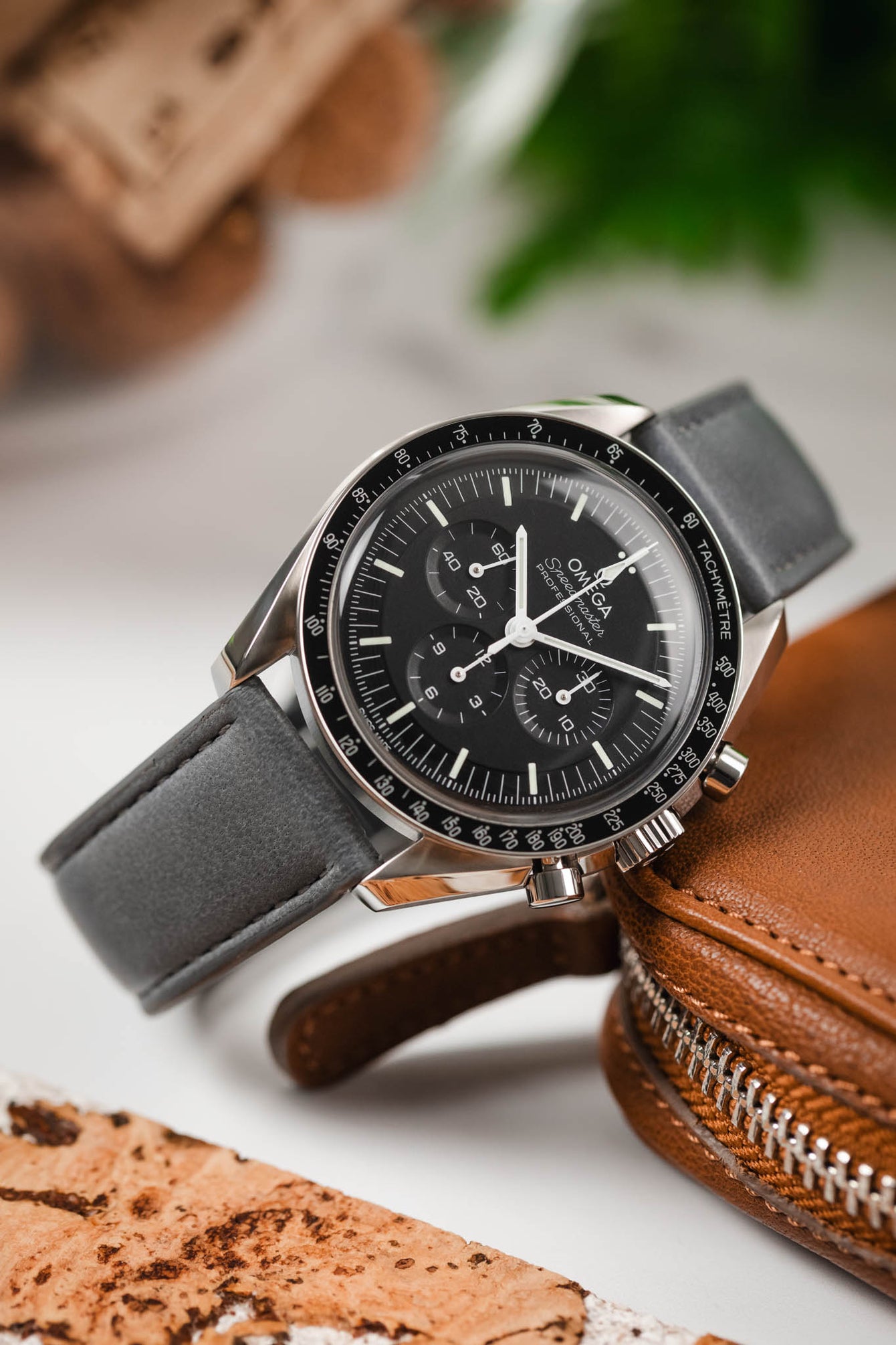 Macro Photography of Omega Speedmaster Pro on Lambskin Merino Strap in Gray with flecto on the hesalite glass