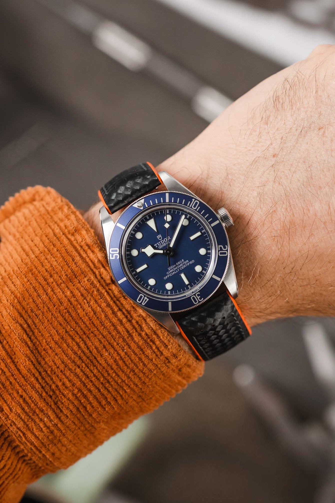 Tudor Black Bay 58 Blue fitted with Hirsch Ayrton Black and orange Carbon embossed watch strap worn on wrist